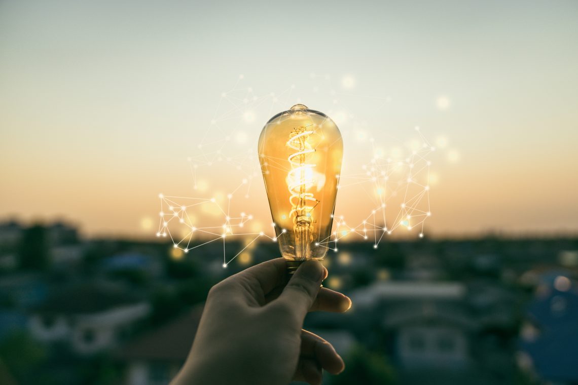 Hand business man holding light bulb with light line. Alternative energy, idea, saving electricity innovation and inspiration concepts.